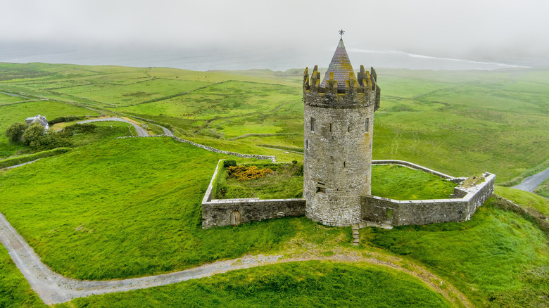 Doonagore Castle in Doolin, Ireland, surrounded by green grass
