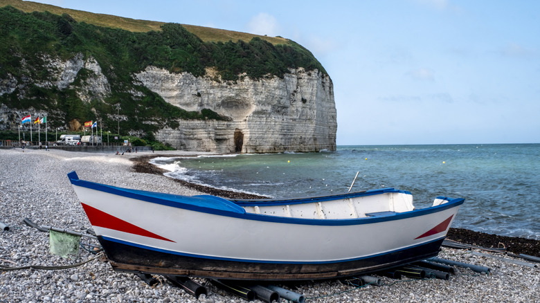 Red, white, and blue traditional fisherman's boat on the beach of Yport, France