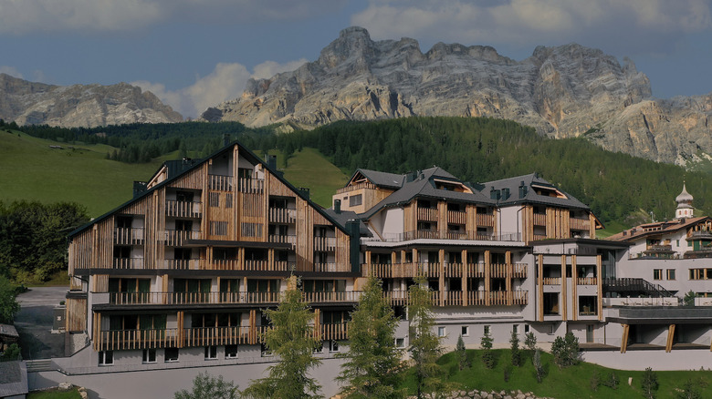 The new Aman Rosa Alpina stands framed by the forested hills and limestone karsts of the Alps