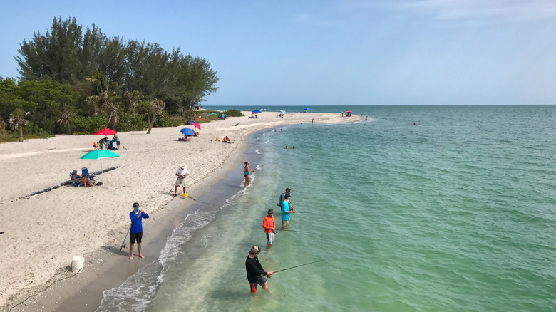 A group of people fishing at Blind Pass Beach