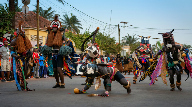 Dancers in traditional costumes during a parade on the Bijagos Islands
