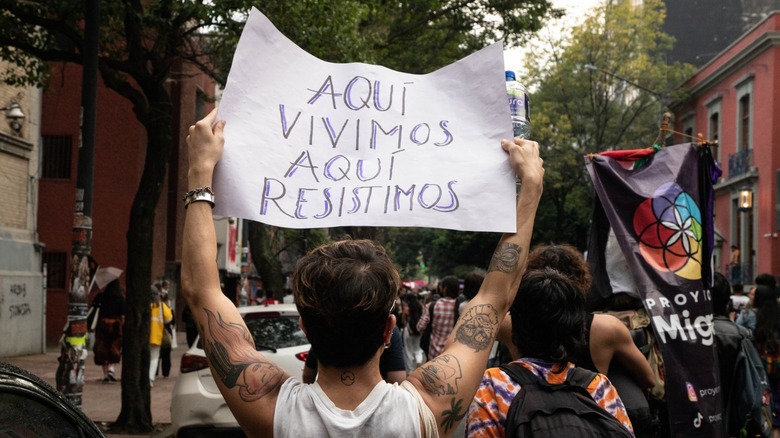A protester in Mexico City holds a sign against rising rents in the city