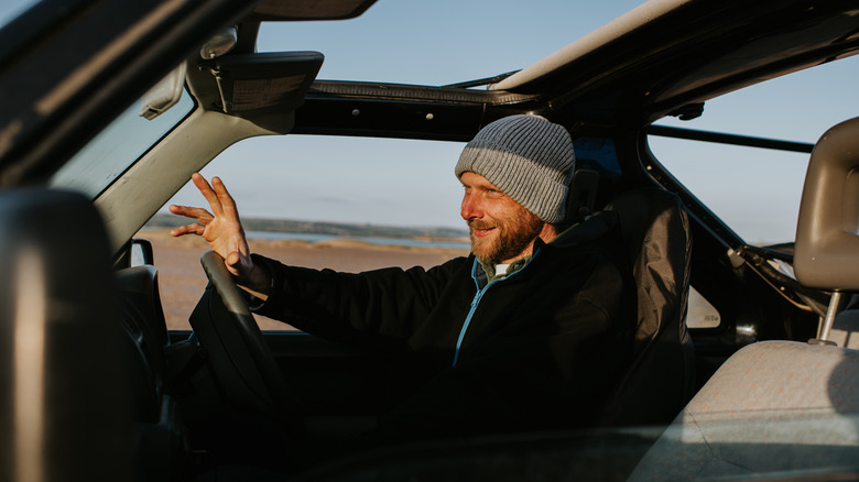 Man driving in a truck on a road trip