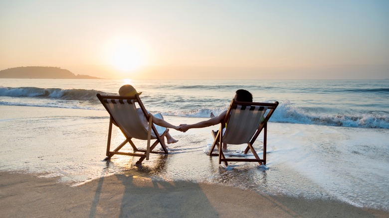 Couple holding hands on beach 