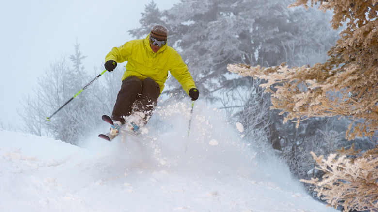 Person skiing down snowy hill in Stowe, Vermont