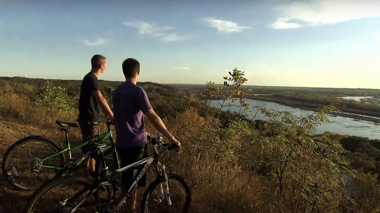 Two cyclists look out at the sky in Hitchcock Nature Center
