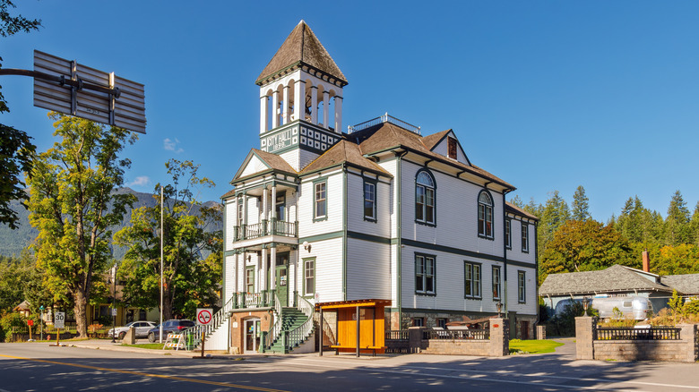 White and green historic city hall Kaslo Canada blue sky