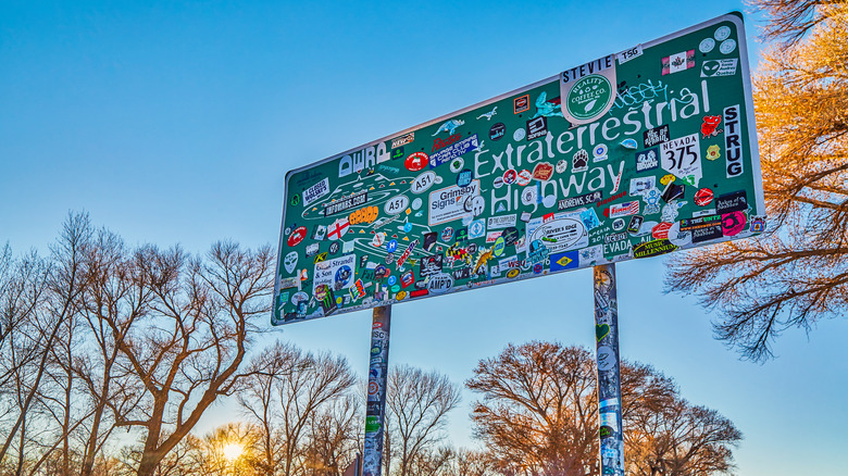 Sign post for Extraterrestrial Highway is decorated with stickers