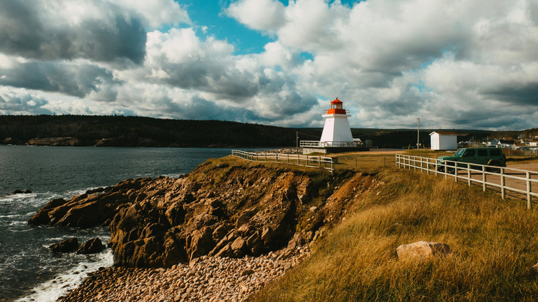 A lighthouse on a cliff in Cape Breton Highlands National Park in Canada