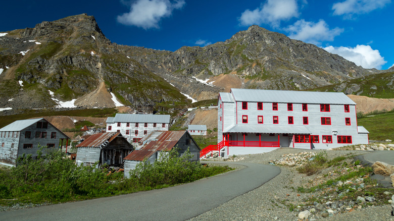 Abandoned mining buildings in front of a mountain in Alaska