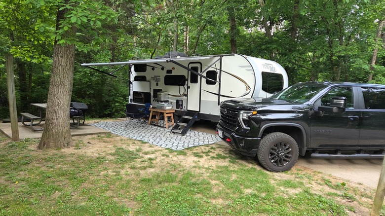 RV camper and a car parked between trees at Dr. Edmund A. Babler Memorial State Park, Missouri