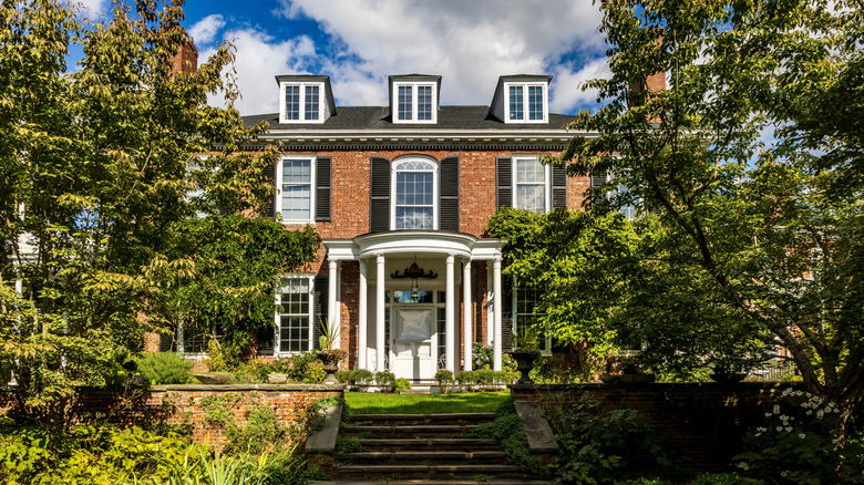 A home in Beverly, Massachusetts, partially concealed by trees