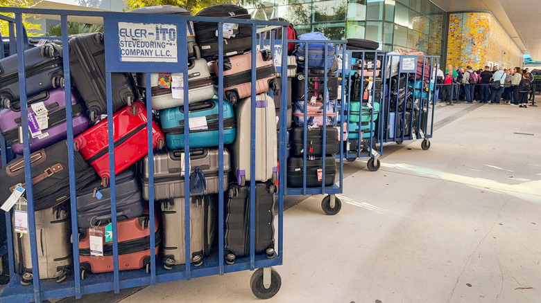 Luggage stacked in rolling carts to load on a cruise ship