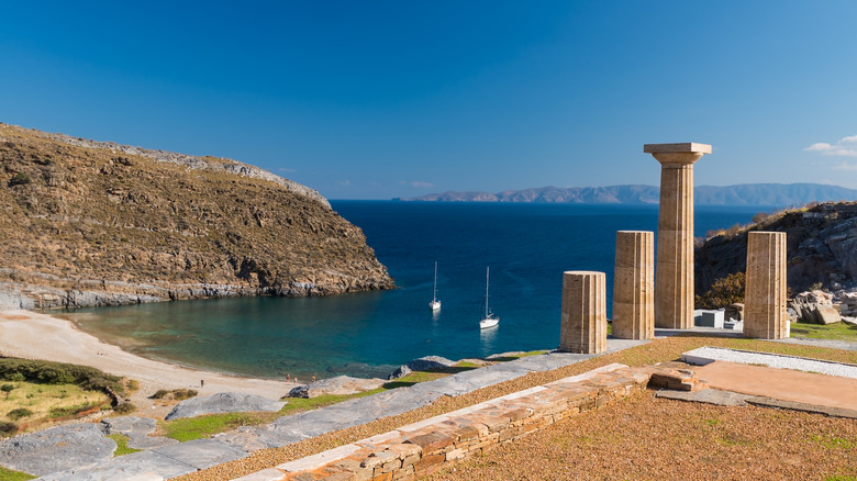 Historic temple ruins above a sandy beach in Karthea, Kea