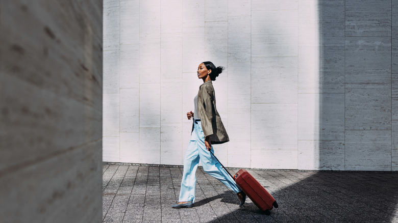 Traveler walking with roller suitcase