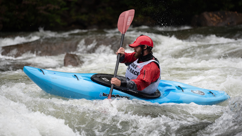 A kayaker paddling on a powerful river.