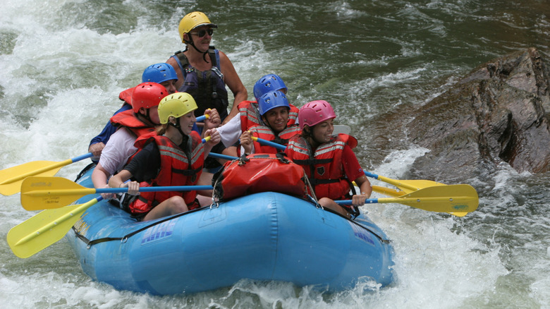 A group of people whitewater rafting on a river