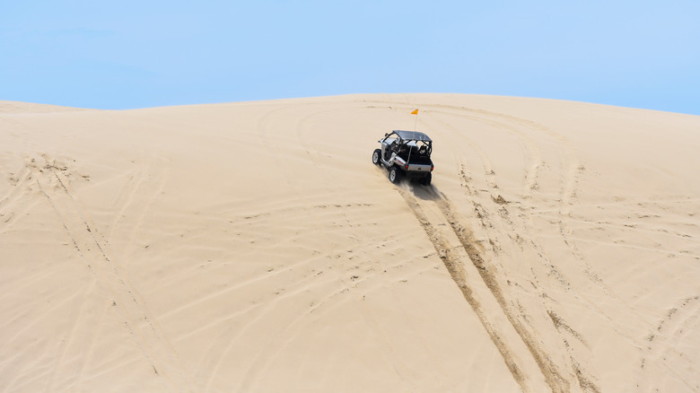 An ATV climbing a dune on the Oregon Coast