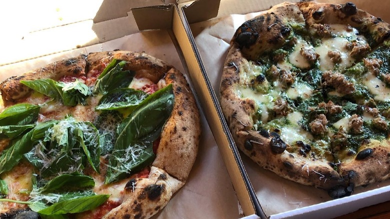 Two pizzas in open cardboard boxes at The Carlson Block, in Wilkeson, Washington.
