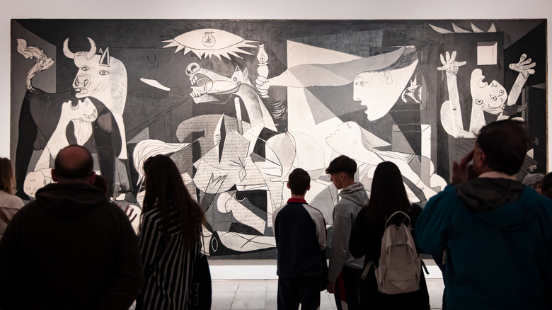 Museum visitors admiring Picasso's Guernica in the Reina Sofia Museum