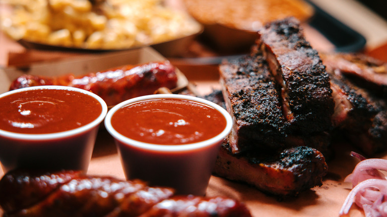 Ribs, sausage, and sauce on classic barbecue platter
