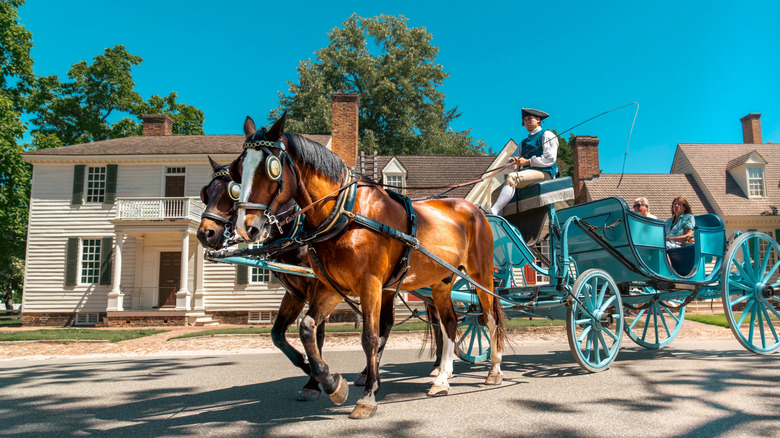 A horse drawn carriage takes visitors through Colonial Williamsburg