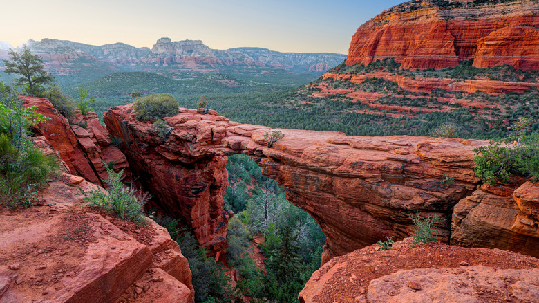 The Devil's Bridge arch in Sedona, Arizona surrounded by red rock canyon views