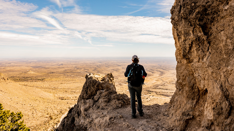 Woman on mountain over vast desert
