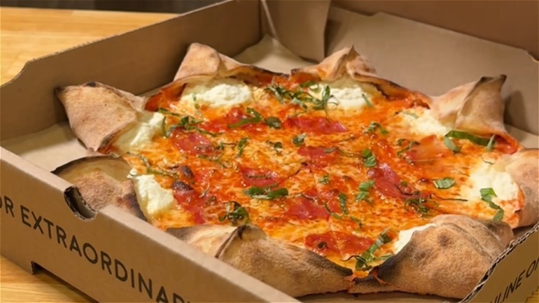 Fresh pizza in a cardboard pizza box