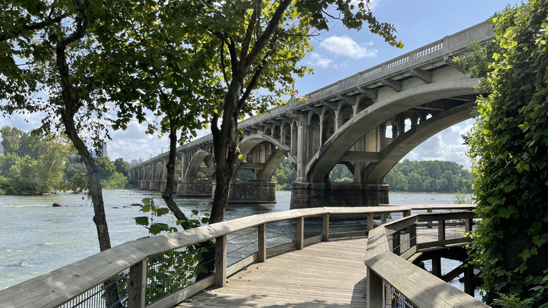 a walkway along the Congaree river with Columbia in the background