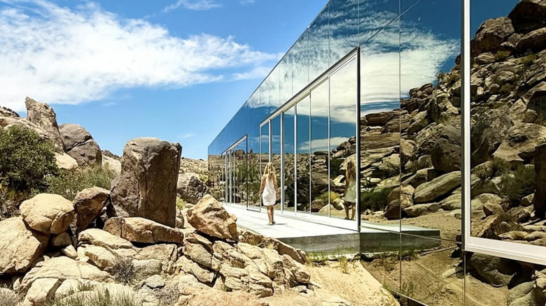 Woman walking on the side of The Invisible House