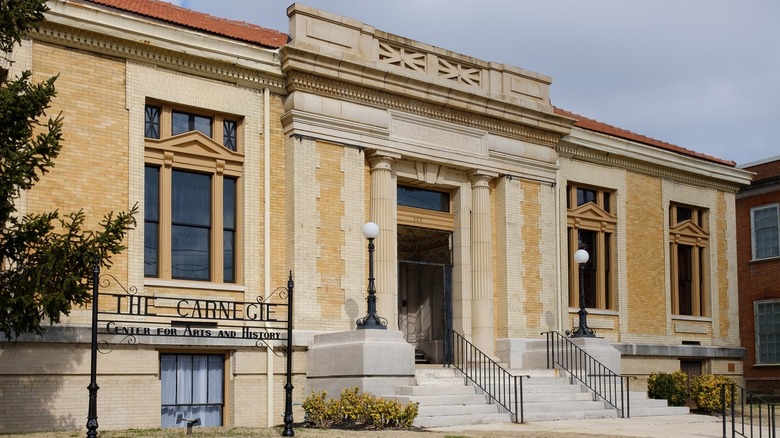 Yellow brick building with sign reading The Carnegie Center for Arts and History