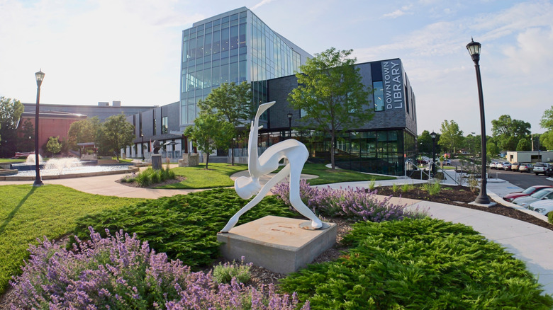 View of a statue in front of the public library in downtown Olathe, Kansas.