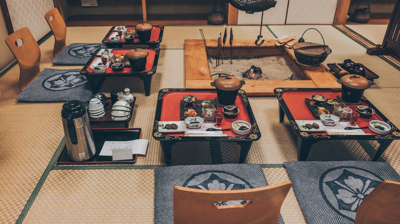 A Japanese gourmet kaiseki dinner with a traditional irori fireplace in ryokan.