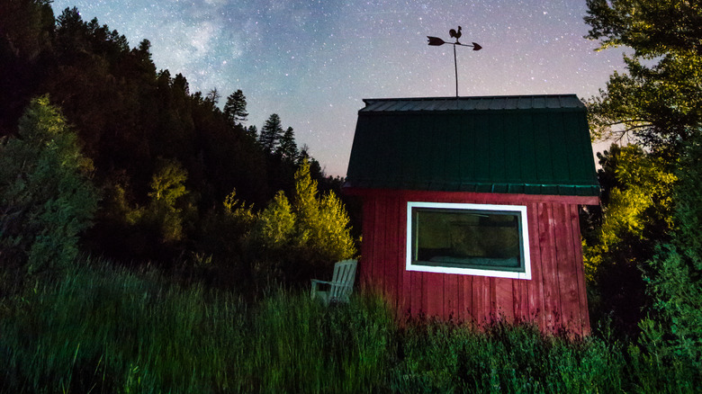 A starry sky over a red shed in Dolores, Colorado
