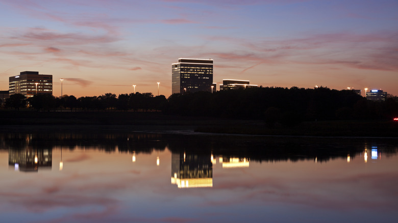 The lights of office buildings reflecting off the lake