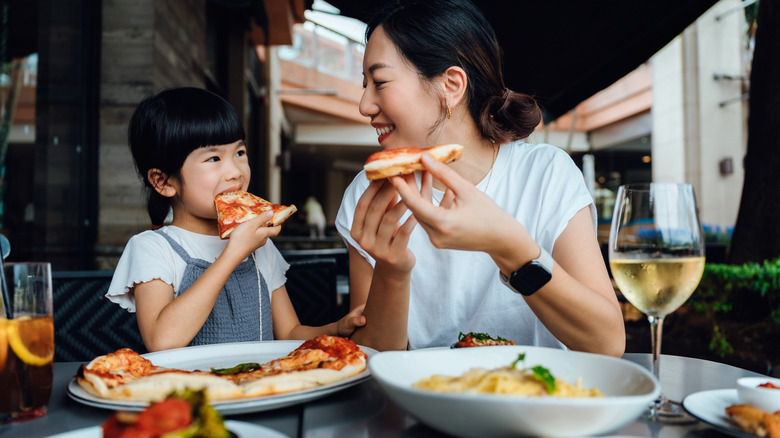 Mother and son eating pizza