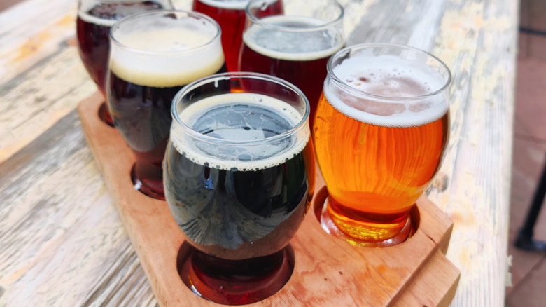 Glasses of beer on a wooden serving tray