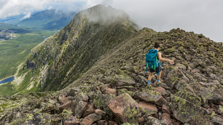 Hiker navigating rocks on Mount Katahdin in Baxter State Park, Maine