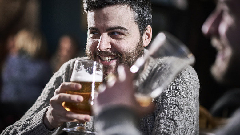 Two friends enjoying a beer at a pub