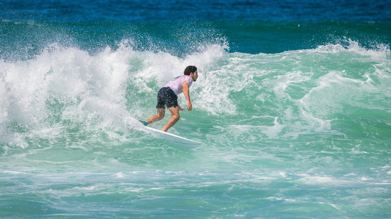 Tourist surfing Weligama's waves.