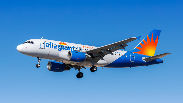 An Allegiant airbus can be seen during take off, backed by a clear blue sky