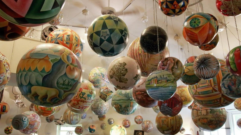 Painted spheres hanging from Termesphere Gallery's ceiling