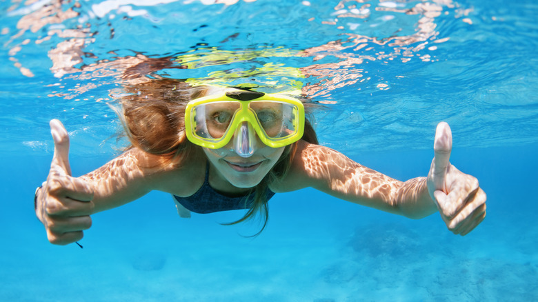 Woman snorkeling in clear water