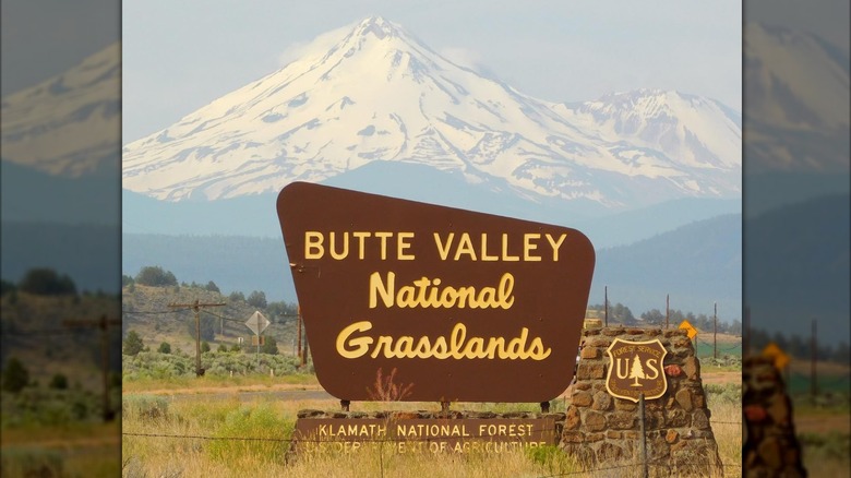 Butte Valley National Grasslands sign in front of snowy mountain