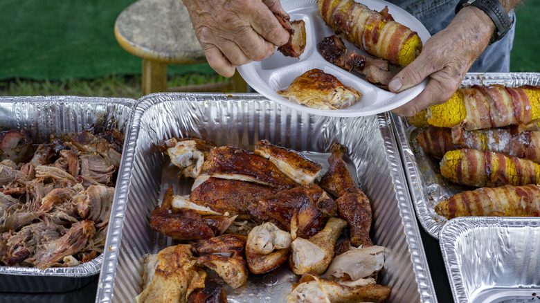 Man fills his plate with barbecue