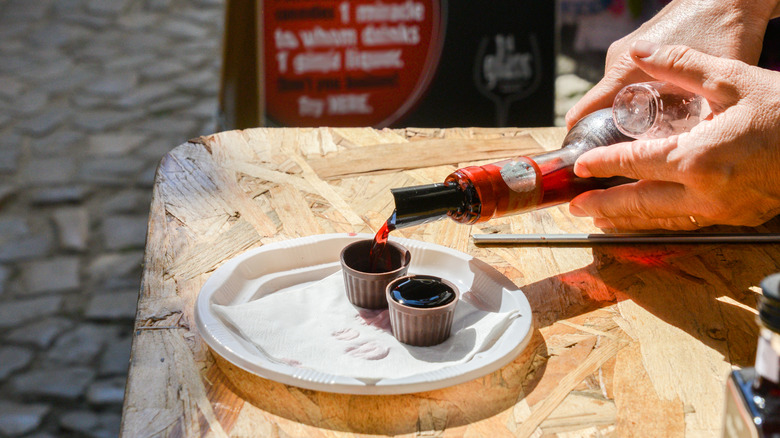 Óbidos' traditional cherry liqueur being poured into a chocolate cup