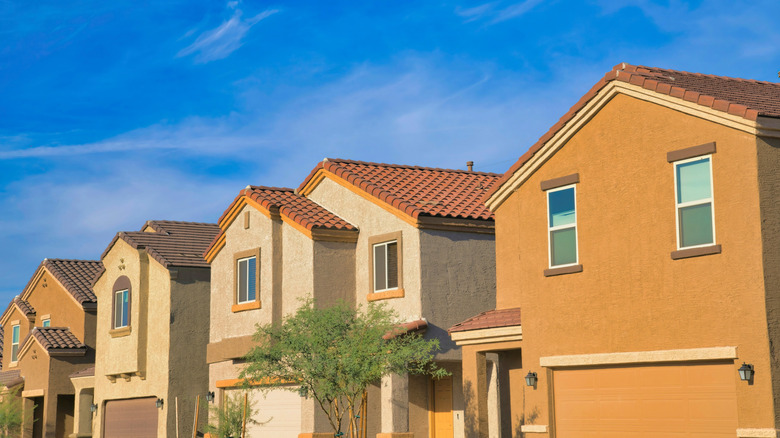 Row of suburban 2-story houses with clay tile roofs