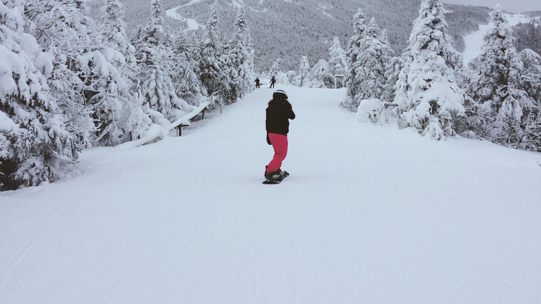 A snowboarder going down a hill at Jay Peak, near Troy