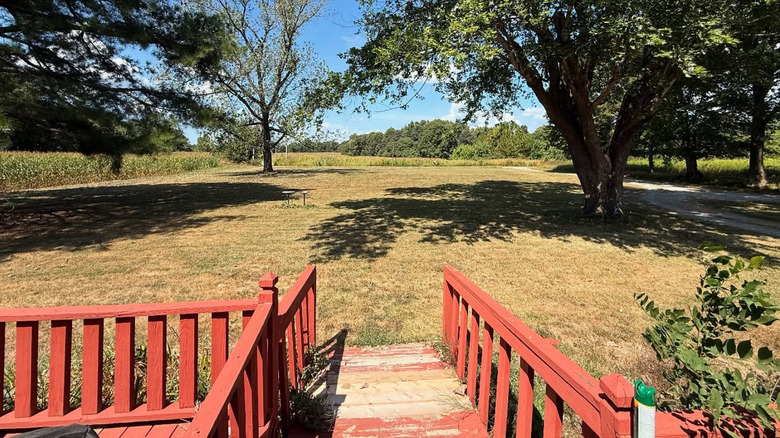 Red deck and sprawling field and grounds in Hardinsburg, Kentucky